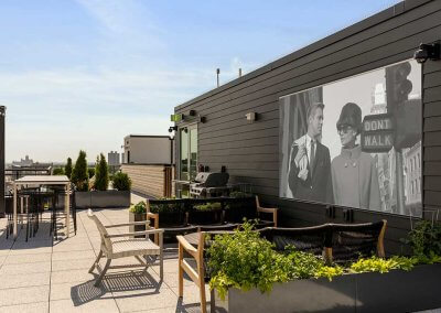 Photo of rooftop entertainment space showing movie screen and seating area
