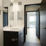 View of modern bathroom leading into bedroom