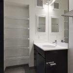 View of modern bathroom with large linen closet