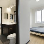 View of modern bedroom and bathroom showing 2 access doors to bath